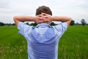A man experiencing Excessive sweating on his back. Remington Laser Dermatology can treat sweat glands.