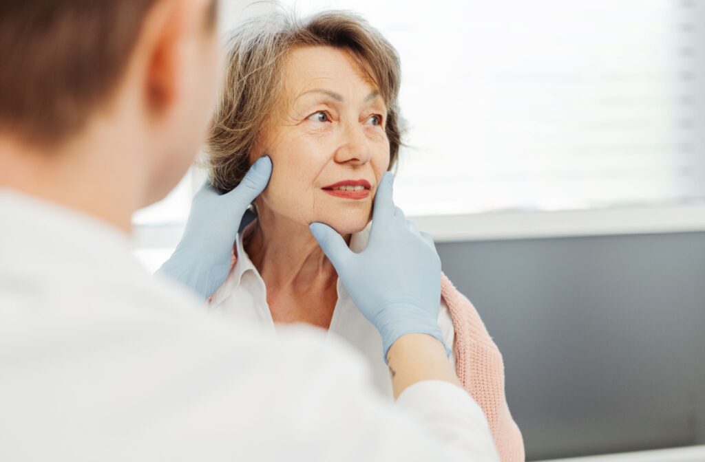 A dermatologist examines a patient's eyelids to determine the best skin tag removal option.